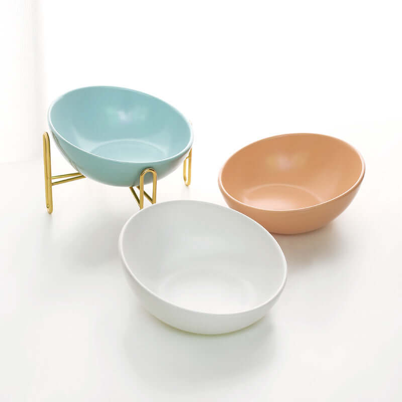 Ceramic Pet Bowls in pastel colors with gold stands, perfect for stylish pet feeding.