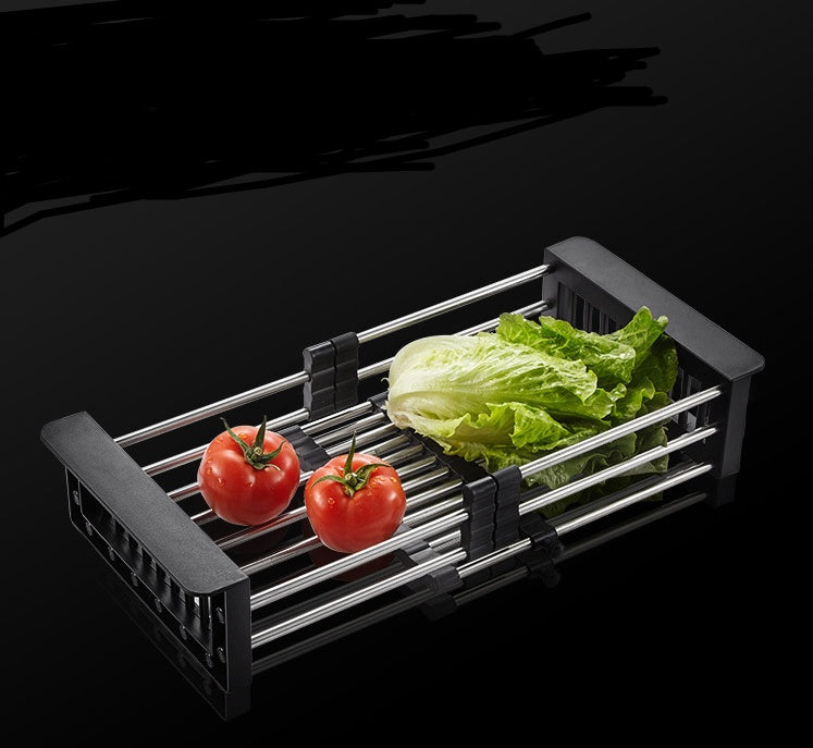 Stainless steel kitchen sink drain basket with tomatoes and lettuce, perfect for food prep and drainage.