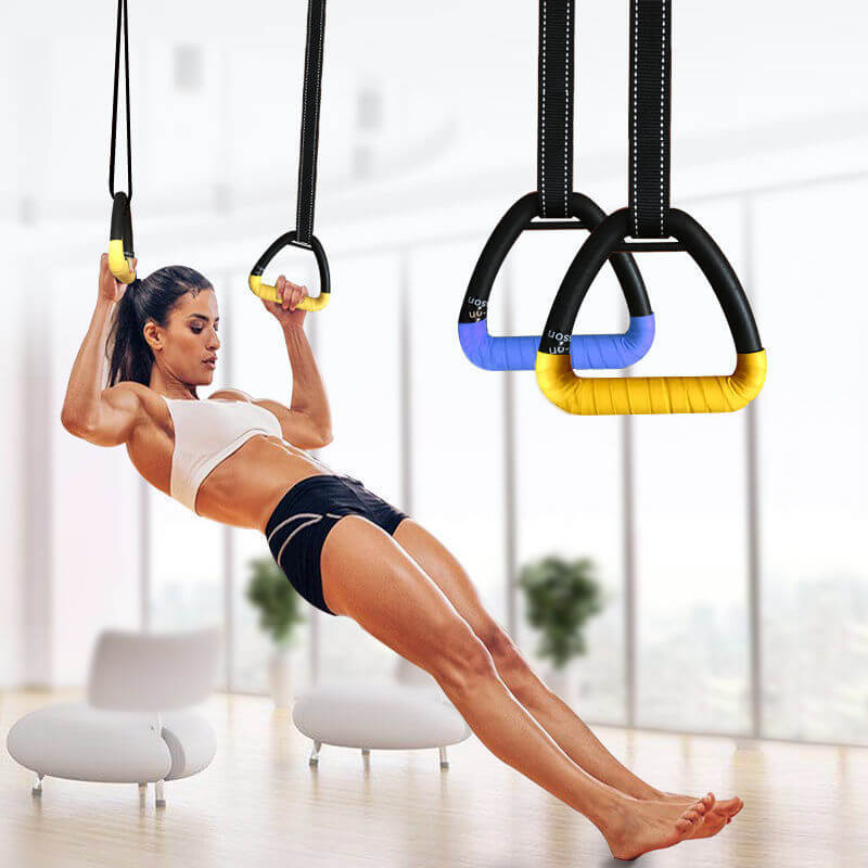 Woman using Ring fitness home suspension training rings for exercise indoors.