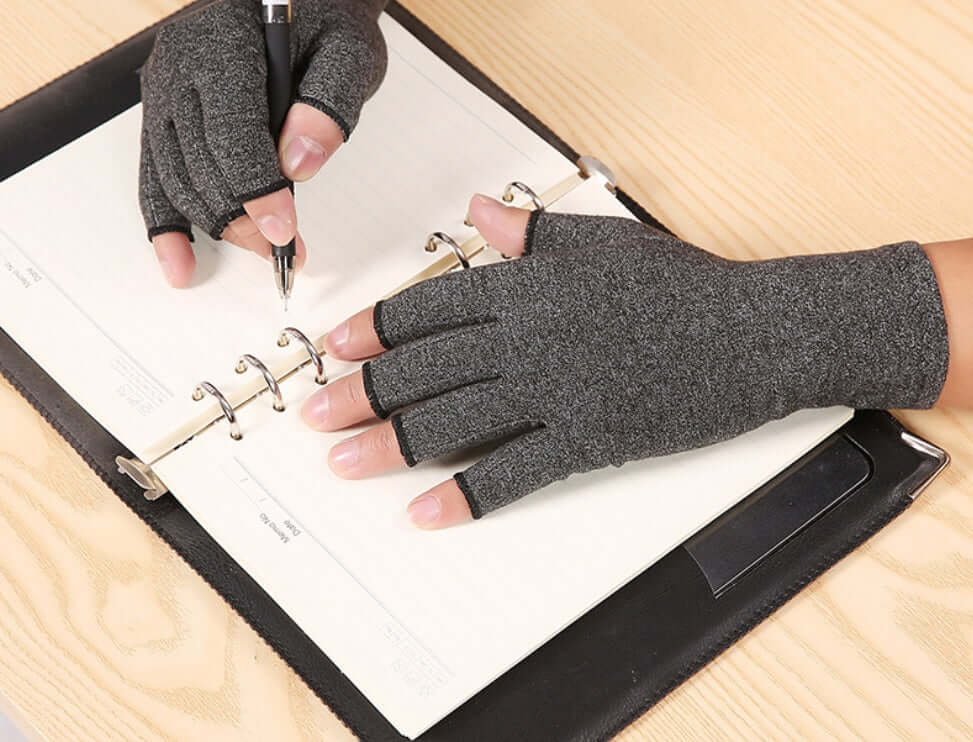 Person using Breathable Health Care Half Finger Gloves while writing in a planner.