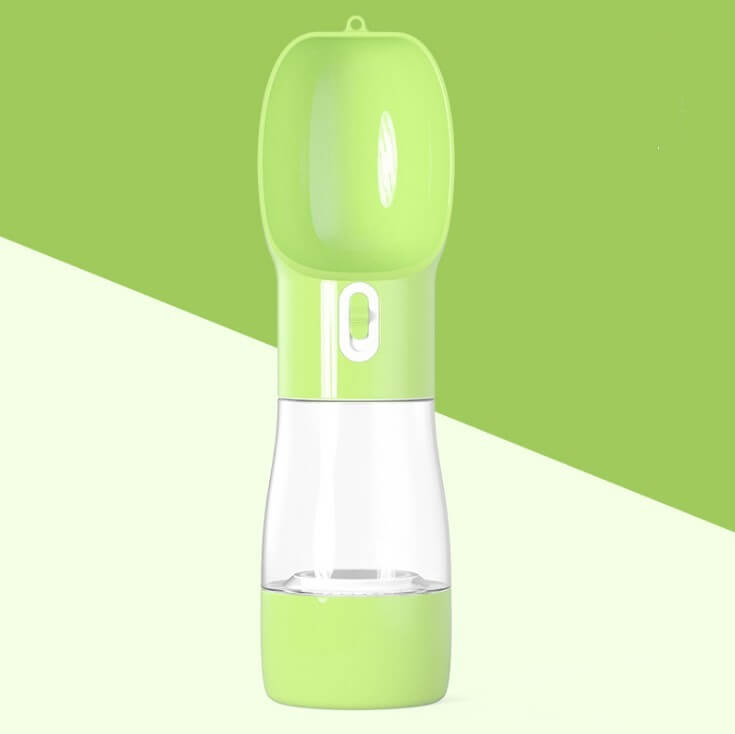 Portable pet water dispenser for travel, designed for outdoor use with a green color and ergonomic shape.