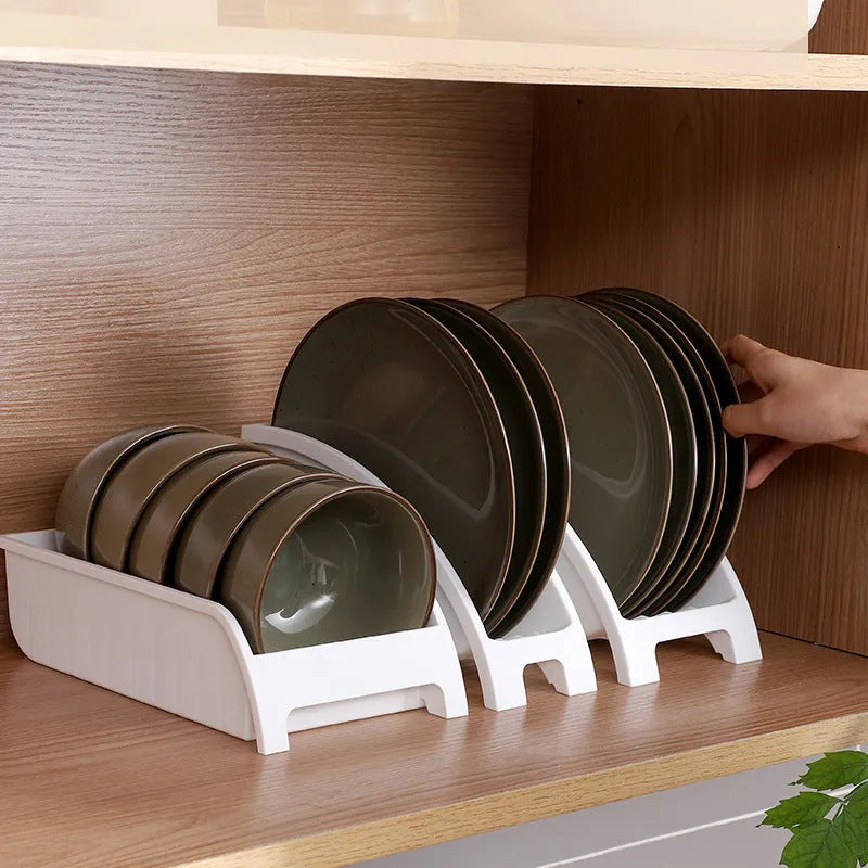 Multifunctional kitchen tableware rack displaying bowls and plates in a kitchen cabinet.