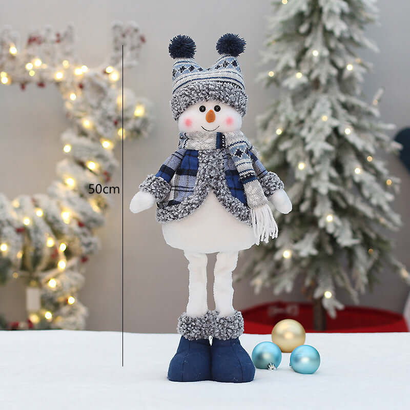Christmas New Product Blue Fabric Expandable Snowman Doll Adornment Decoration in winter setting with lights.