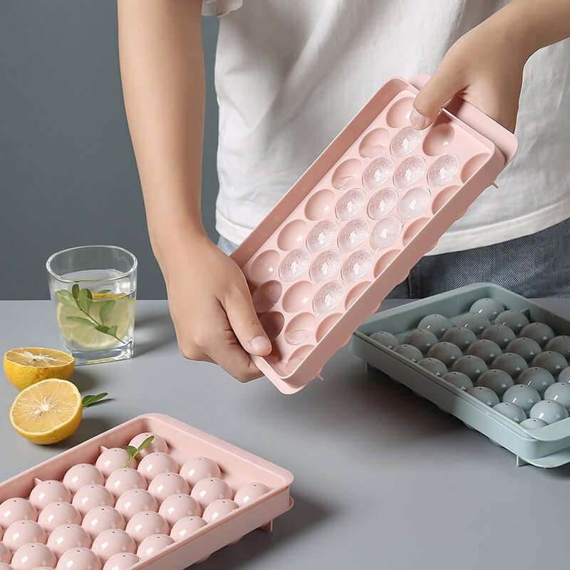 Person holding 3D round ice cube mold for drinks, showcasing innovative design for ice cubes.