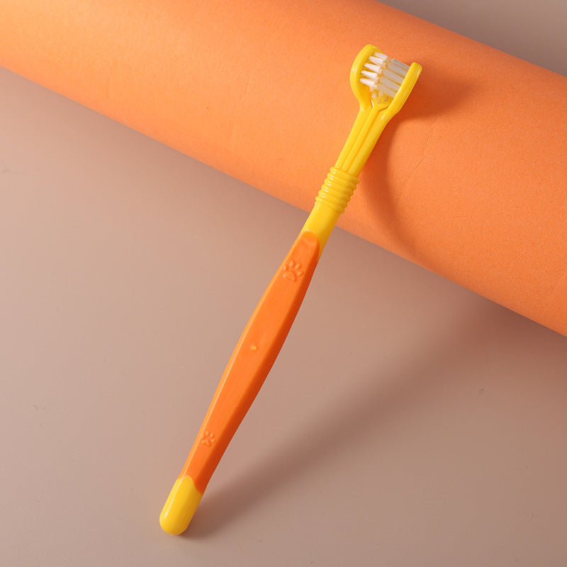 Pet toothbrush oral care in yellow color on an orange background, designed for effective pet dental hygiene.