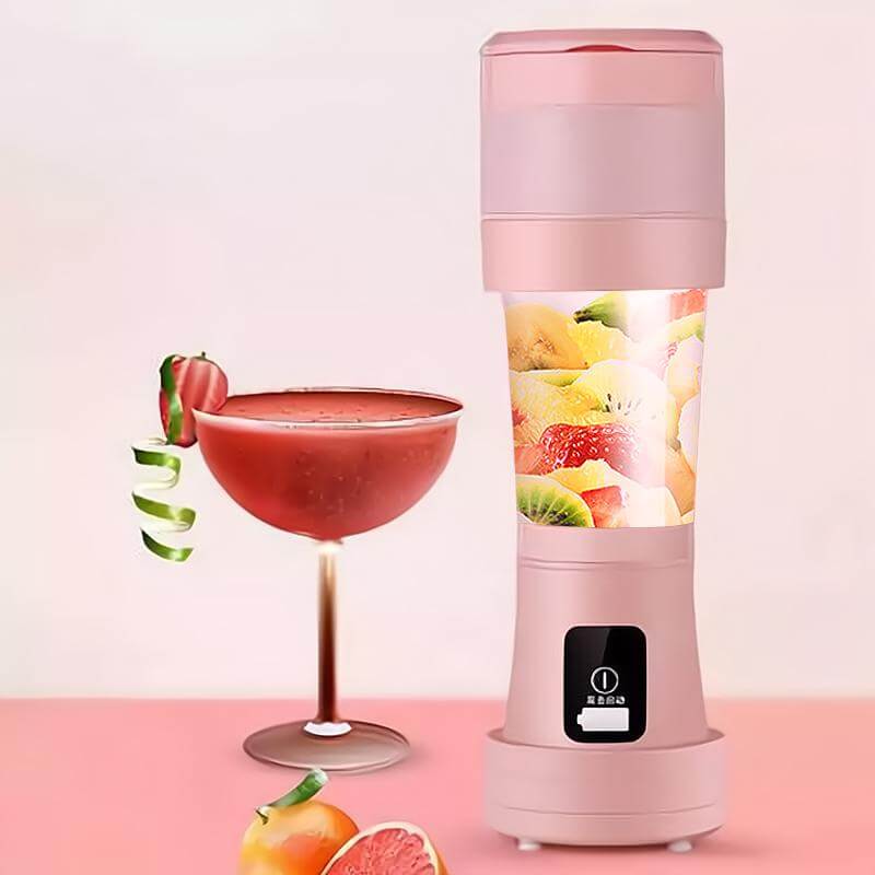 mini portable blender for smoothies beside a fresh cocktail and fruits in a stylish setting.