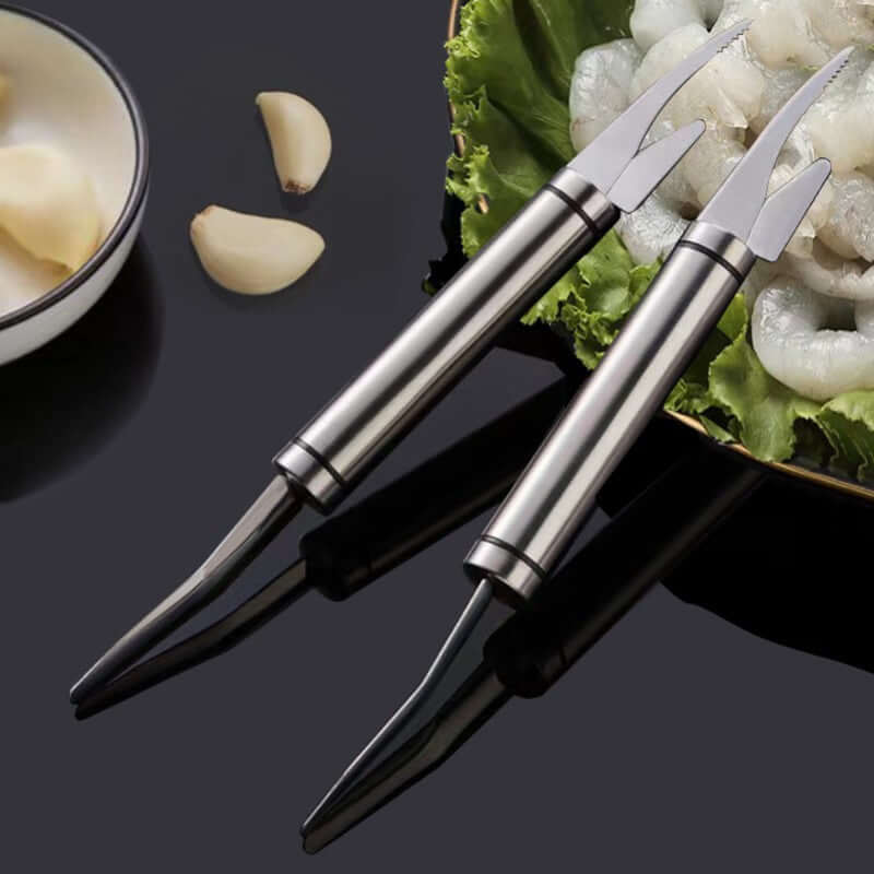 Multifunction Stainless Steel Shrimp Deveiner & Fish Scale Remover Tool on a serving platter with shrimp and garlic.